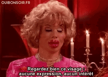 a woman in a pink dress with big lips says regardez bien ce visage aucune expression aucun interest