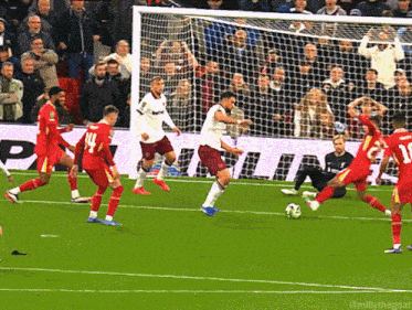 a group of soccer players are playing on a field with a sign that says phillips