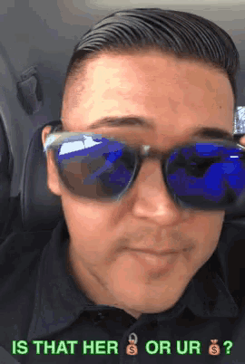 a man wearing sunglasses has the question is that her or ur on the bottom