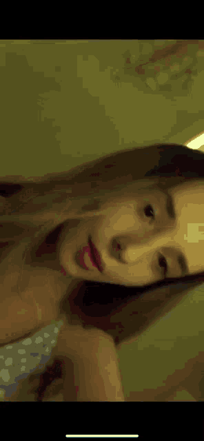 a close up of a woman 's face with her eyes closed and smiling .