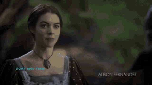 a woman in a gray dress is standing in a stream with the word epic tales written on the bottom