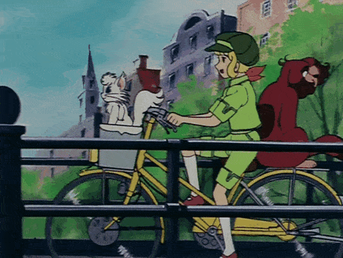 a girl is riding a bicycle with a cat in the basket