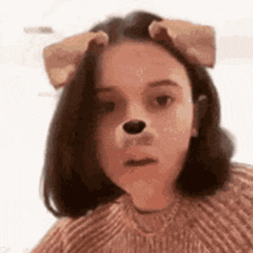 a girl wearing a dog mask on her face .