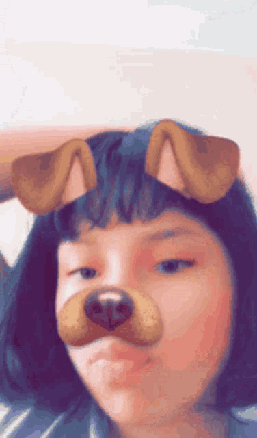 a girl wearing a dog face mask looks at the camera
