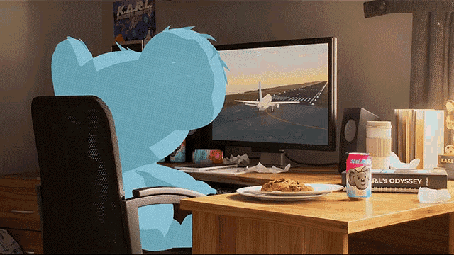 a koala bear is sitting in front of a computer with a karl poster behind it