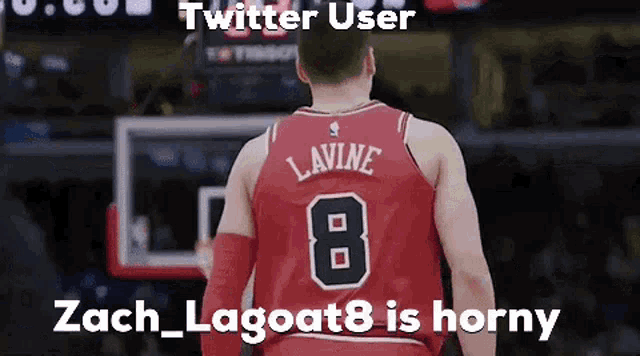 a basketball player wearing a red jersey with the number 8 on it .