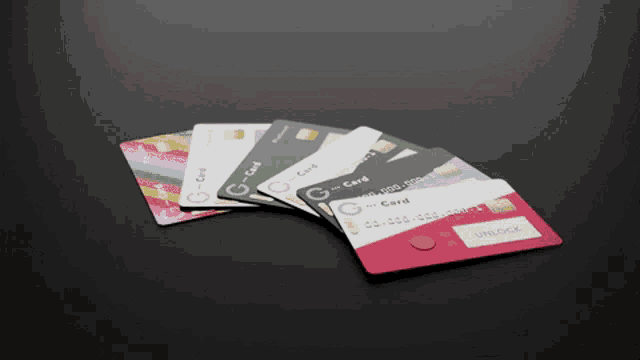 a bunch of credit cards are stacked on top of each other with one that says unlock on it