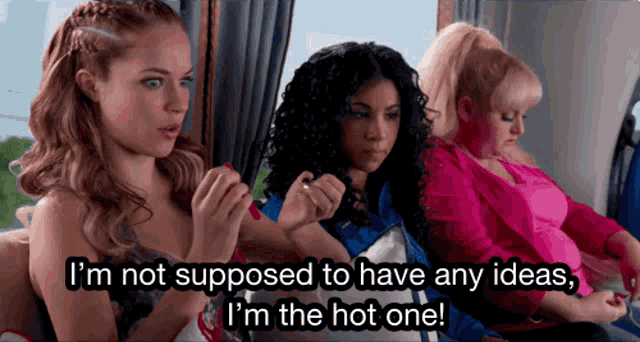 three women are sitting on a bus and one of them is saying i 'm not supposed