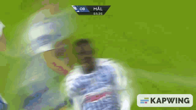 a soccer player in a blue and white striped jersey is being kicked by another player