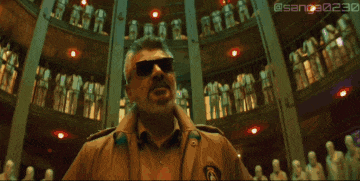 a man wearing sunglasses says no in front of a crowd