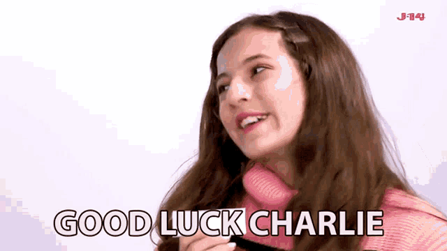 a girl in a pink sweater says good luck charlie on a white background
