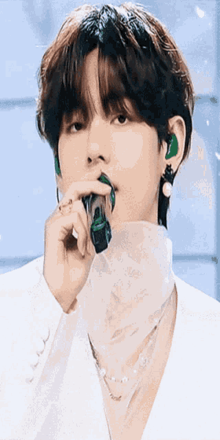 a close up of a person holding a microphone in their hand