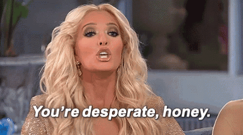 a blonde woman is sitting on a couch and saying `` you 're desperate honey . ''