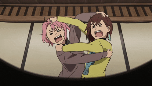 a girl with pink hair and a girl with brown hair are hugging each other