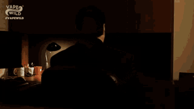 a man is sitting at a desk with the words buongiorno written on it