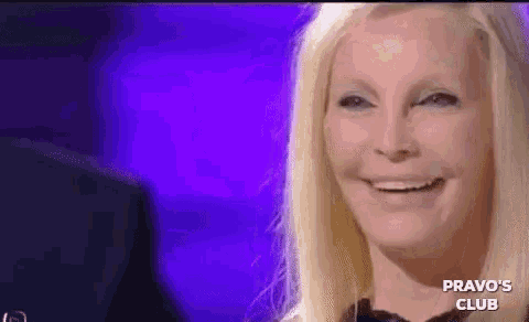 a woman is smiling in front of a purple background with the words pravo 's club on the bottom right