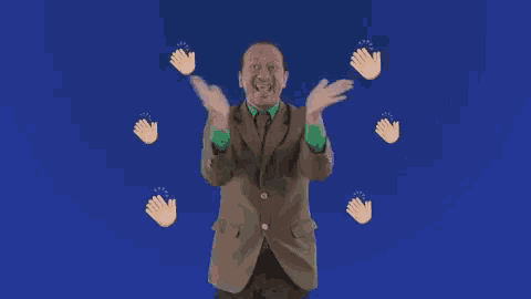 a man in a suit is clapping his hands surrounded by clapping hands