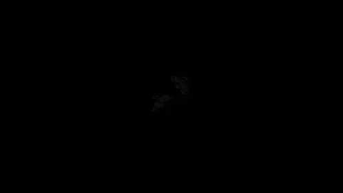 a white light is shining in the middle of a red background