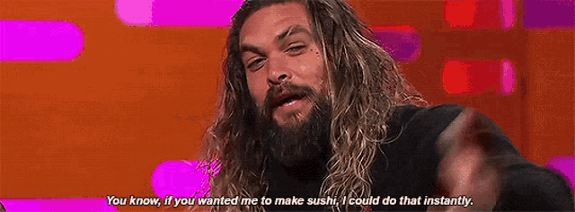 a man with long hair and a beard is talking on a stage and saying `` you know , if you wanted me to make sushi