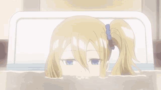a girl in a bathtub with her head sticking out of it