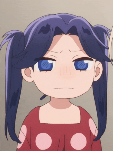 a girl with pigtails and blue eyes making a face