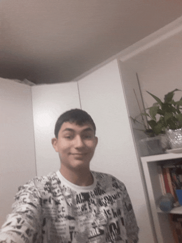 a young man taking a selfie wearing a shirt that says ' all boys ' on it
