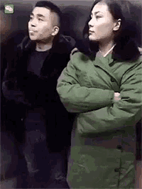 a man and woman are standing next to each other with their arms crossed .
