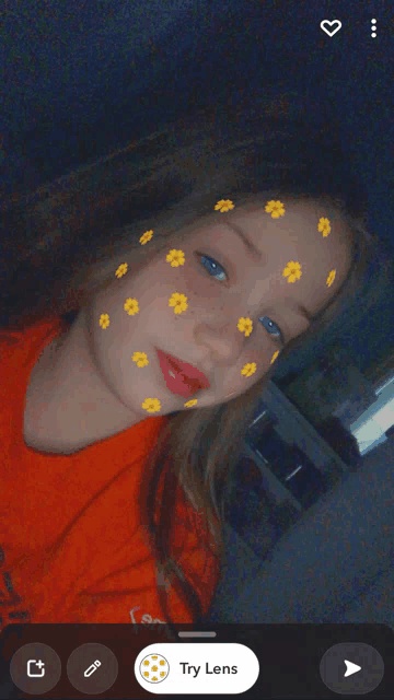 a girl with yellow flowers on her face is taking a selfie