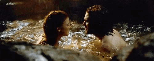 a man and a woman are kissing in a pool of water