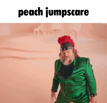 a man in a green suit and a red hat is standing in the desert .