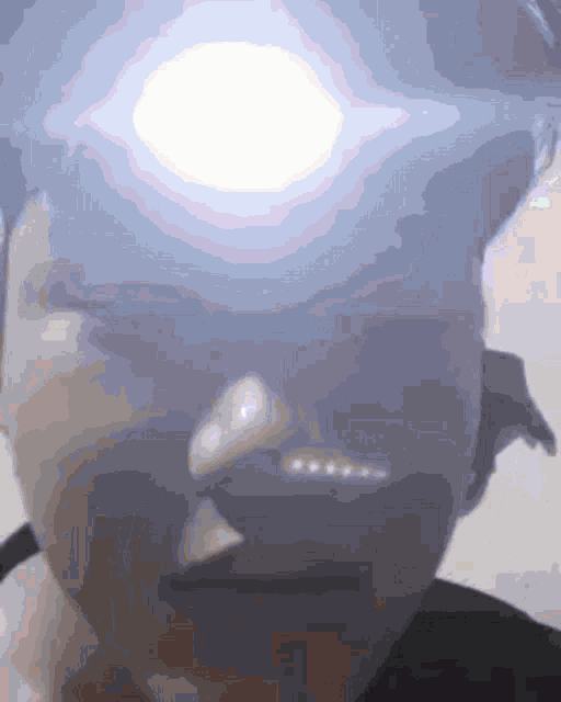 a close up of a person 's face with a glowing eye
