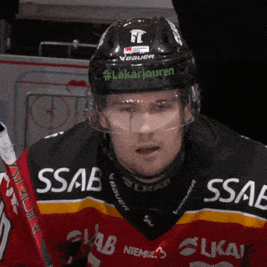 a hockey player wearing a black helmet with bauer on it