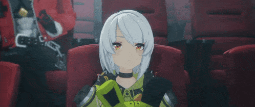 a girl eating a hamburger in a movie theater