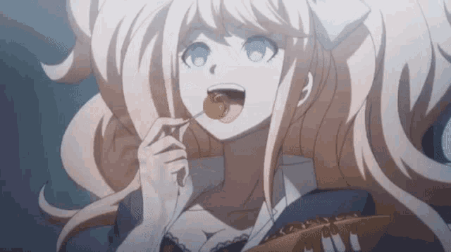 a girl with long blonde hair is eating a piece of food with her tongue out .