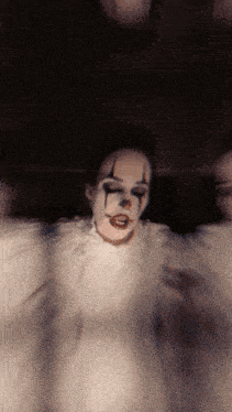 a person dressed as a clown with tears on their eyes