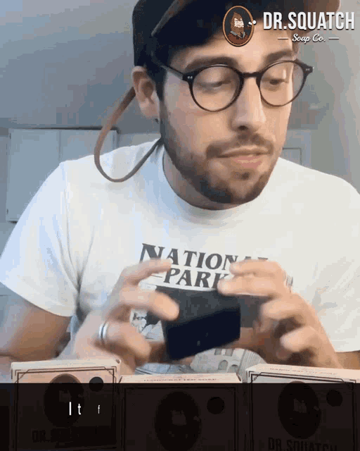a man wearing glasses and a shirt that says " national park "