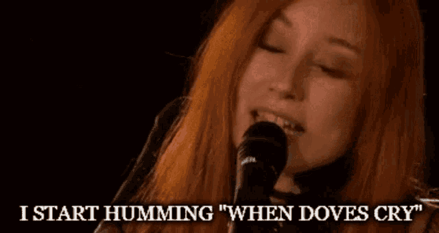 a woman singing into a microphone with the words " i start humming when doves cry "