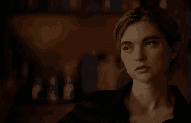 a close up of a woman 's face with a blurred background