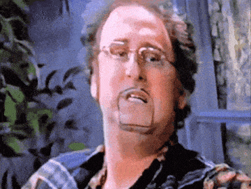a man with glasses and a mustache is making a face