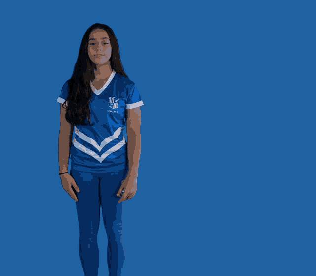 a girl wearing a blue and white shirt that says nfl on it