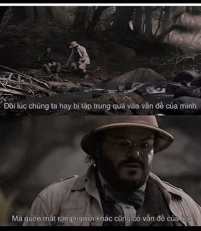 a man in a hat and glasses is talking to another man in a river