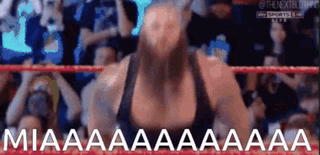 a woman in a wrestling ring is screaming miaaaaaaaaa