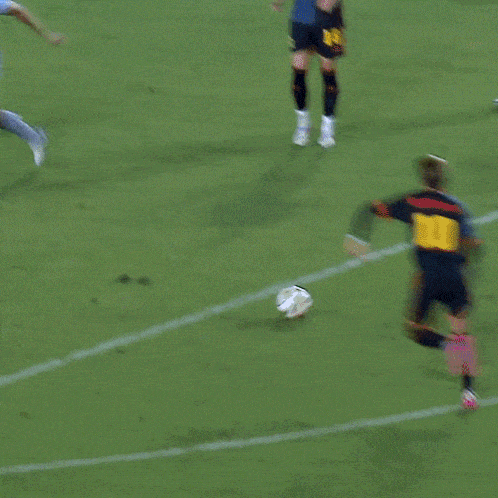 a soccer game is being played in front of a sign for adidas