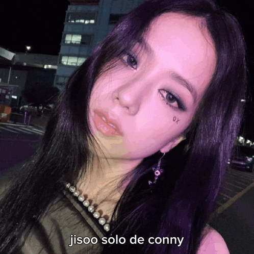 a close up of a woman 's face with jisoo solo de conny written below her