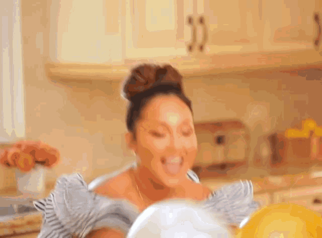 a woman in a kitchen is using a blender to mix something