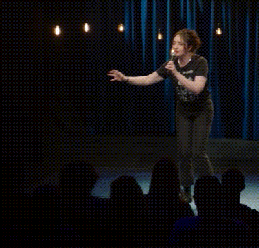 a woman is giving a speech in front of a crowd with the words high five on the bottom