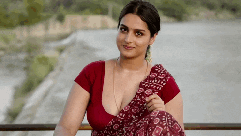 a woman in a red top and a purple saree