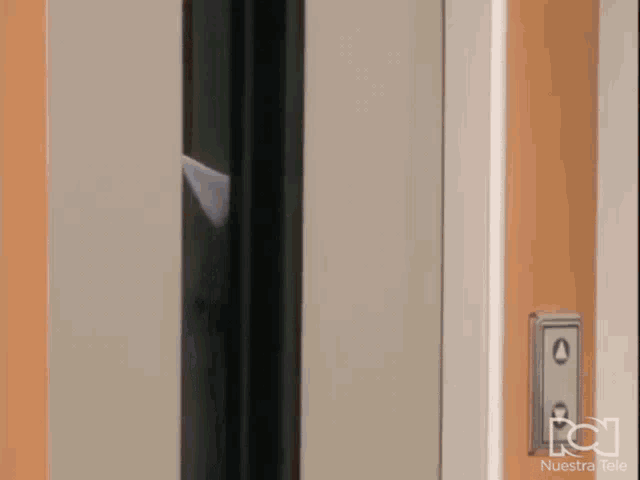 a close up of an elevator door with nuestra tele written on the bottom