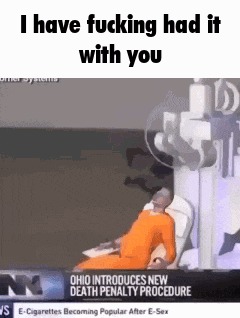 a man in an orange jumpsuit is laying in a hospital bed with a newspaper headline .