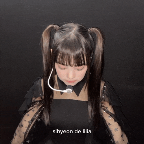 a girl with pigtails has the name sihyeon de lilia on the bottom right